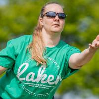 A player throws a bag wearing a green Laker shirt